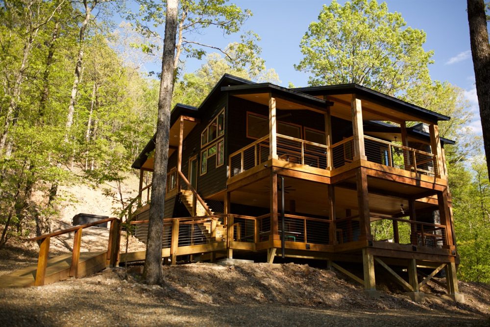 Luxury cabin nestled in the Broken Bow forest, showcasing a multi-level design with a spacious