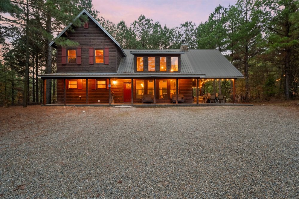Luxury cabin in Broken Bow, Oklahoma, featuring a spacious deck and warm lighting, ideal
